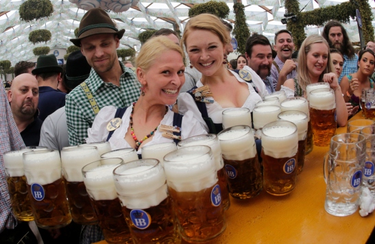Waitresses Beli, right, and Anika pose with beer mugs during the opening of the 181th Oktoberfest beer festival in Munich, southern Germany, Saturday, Sept. 20, 2014. The world's largest beer festival will be held from Sept. 20 to Oct. 5, 2014. (AP Photo/Matthias Schrader) ORG XMIT: MAS122